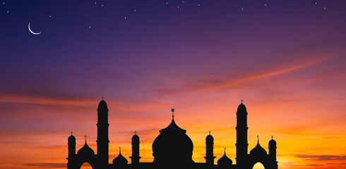 Panoramic view of silhouette mosque dome against colorful dusk sky and crescent moon with stars in...