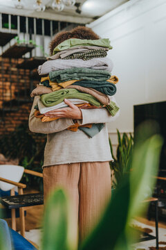 Young fashion designer standing with clothes