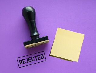 Rubber stamp with stamp text REJECTED on purple background, means refuse to agree to request, not...