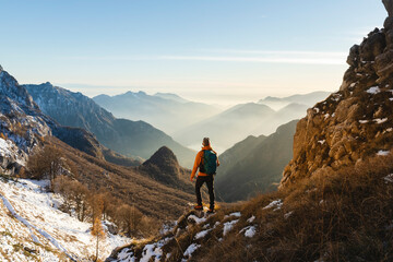 Mature hiker standing in front of mountains