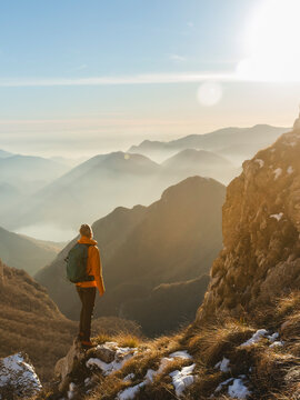 Mature hiker with backpack standing on mountain