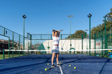Young woman exercising at sports court on sunny day