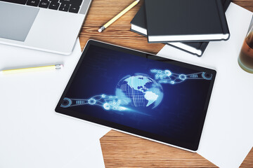 Top view of modern digital tablet monitor with robotics technology and world map hologram. Research and development software concept. 3D Rendering