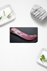 Pork sirloin on a kitchen with some herbs