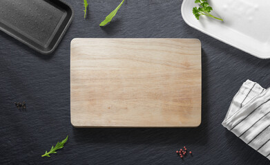 Cutting board on a flat lay of a kitchen or a butcher shop with various items