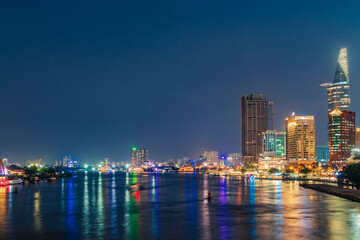 Fototapeta premium Ho Chi Minh City, Vietnam - December 26, 2022: Beautiful night in Ho Chi Minh city known as Saigon, one of the big cities is developed in Vietnam. See Bitexco tower, saigon river and center city view 