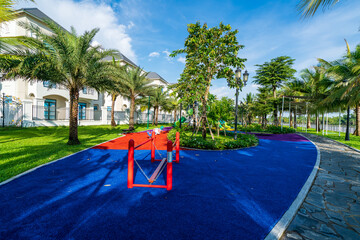 Public green park with modern blocks of flats and blue sky with white clouds in Vietnam