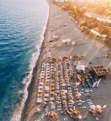 Aerial view of scenic and popular Konyaalti beach in Antalya resort town. Majestic mountains with...