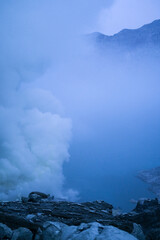Fototapeta premium Mount Ijen Crater is a tourist spot that has a number of interesting panoramas such as blue fire and sunrise. Tourists can observe the activities of sulfur miners in extreme environments.