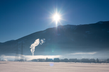 Winter landscape in austria with powerplant and a little village