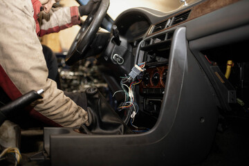 Obraz na płótnie Canvas disassemble the center console of the car torpedo for interior detailing and repair.