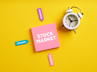 The word stock market on pink note paper. Determinants of stock market prices