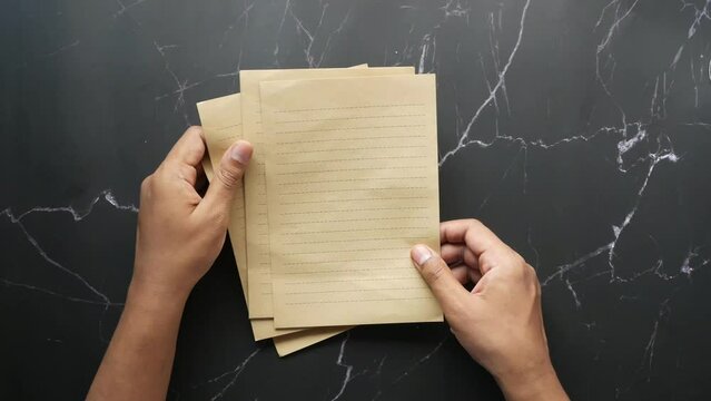  young man hand on blank paper on table 