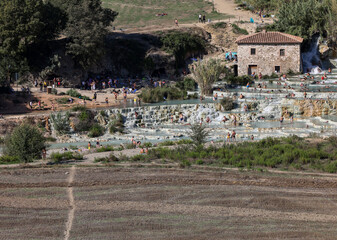 Obraz premium People are bathing in the hot springs of Saturnia Therme, Saturnia, Tuscany, Italy