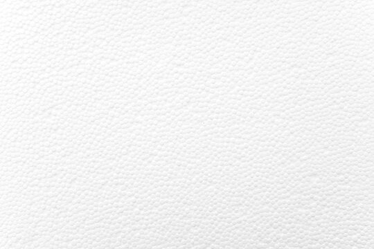 White foam plastic or styrofoam as texture or background, top view, space for text