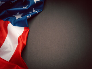 Fototapeta premium The American flag is on a black background with copy space for text