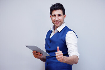 Businessman or young man in suit smiling holding tablet on white background.
