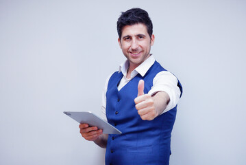 Businessman or young man in suit smiling holding tablet on white background.