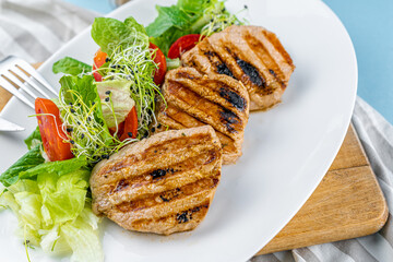 Meat with vegetables. Pork medallions. Grilled meat. Cutlets close-up. Beef Food