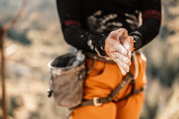 Climber wearing in climbing equipment. Practicing rock-climbing on a rock  mountain wall. Climbing...