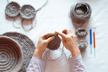 Close-up hands of a woman doing crocheting hands.
