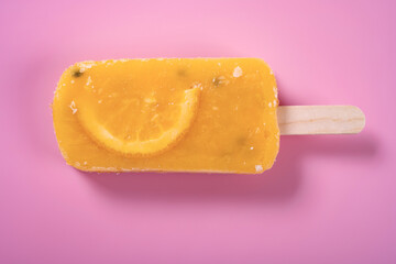 fresh passion fruit flavor popsicle with slice of orange