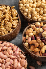 Walnuts, pistachios, hazelnuts and mixed nuts in a bowl on a dark background. Close up