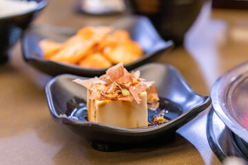 Close up of japanese tofu, Japanese soft cold tofu with sauce in a dish on dining table