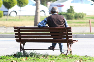 Fototapeta premium rear view of a man sitting on a bench