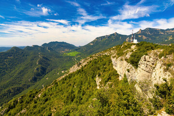 Fototapeta na wymiar View of the top of the Figassa viewpoint, with the mountains of Ensija and the Rasos de Peguera from the Figuerassa viewpoint, Bergueda, Catalonia, Spain