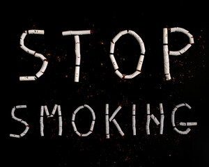 Text stop smoking made from broken cigarettes