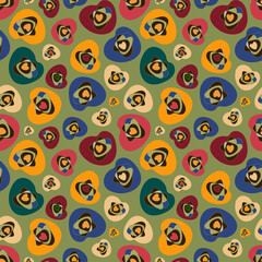 Bright pattern of abstract shapes. Red, yellow, blue hearts on a green background. Seamless vector image.