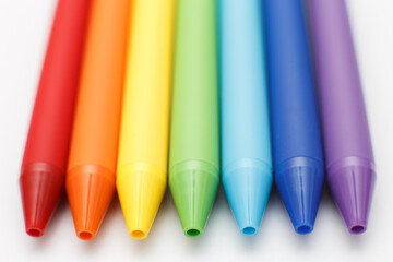 Multicolored in rainbow colors gel pens isolated on a white background, close-up. Copy space