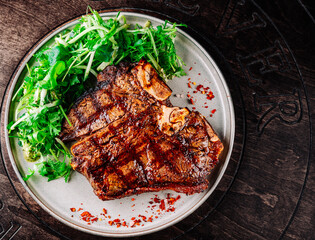 Porterhouse beef steak cooked on a grill on plate