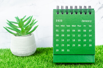 The Green January 2023 Monthly desk calendar for 2023 year on grass.