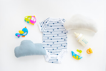 Baby cotton bodysuit with bottle of milk and toys