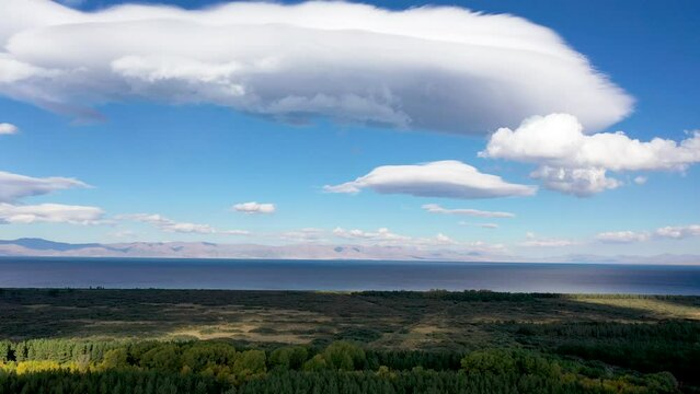  Aerial footage  clouds and lake. Drone fly near Sevan lake in Armenia, Caucasus.  The Shadow of the clouds in the field.
