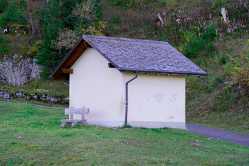 Fototapeta premium Beautiful autumn landscape at Axalp, Canton Bern, with cabin and empty wooden bench on a sunny autumn morning. Photo taken October 18th, 2022, Axalp, Switzerland.