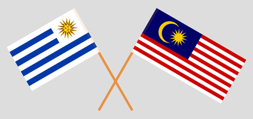 Crossed flags of Uruguay and Malaysia. Official colors. Correct proportion