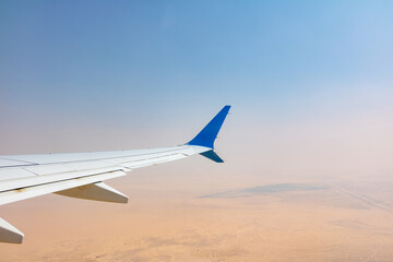 Fototapeta na wymiar a plane flying over the desert 