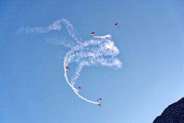 Parachutists of Swiss Army jumped from Pilatus PC-6 airplane at Swiss Axalp Air Display 2020, Canton Bern, on a sunny autumn afternoon. Photo taken October 18th, 2022, Axalp, Switzerland.