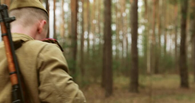 Man Dressed As Russian Soviet Infantry Red Army Soldier Of World War II Marching Walking Along Forest Lane Road In Spring Autumn Day.
