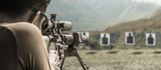 Military soldier sniper shooter aim assault rifle weapon at outdoor academy shooting range