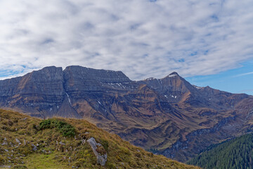 Fototapeta premium Scenic view from top of Axalp over Bernese Oberland with beautiful mountain panorama of the Swiss Alps on a sunny autumn day. Photo taken October 18th, 2022, Axalp, Switzerland.