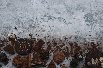 Various of chocolate stuff spread on gray background with copy space. 