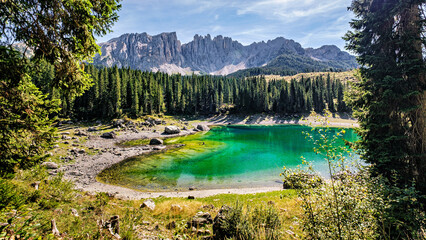 Incredible panoramic view of the Lake Carezza (Italian: Lago di Carezza, German: Karersee), a small...