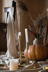 Interior decor with pumpkins, fabrics, lights, dried flowers