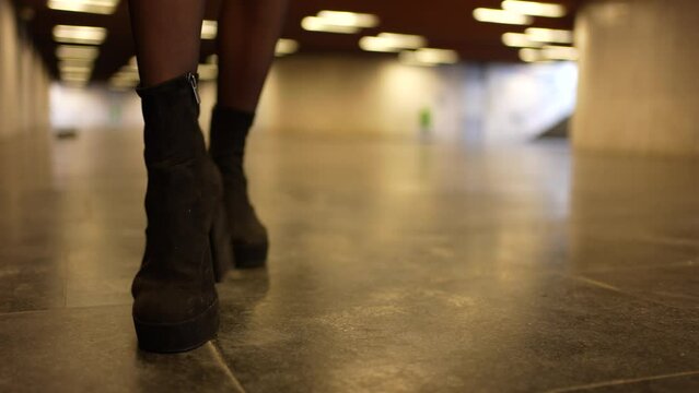 Girl walking down with long legs and heels stepping on a butt