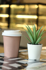 take away paper coffee cup o on cafe table