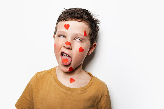 Funny boy with hearts on face